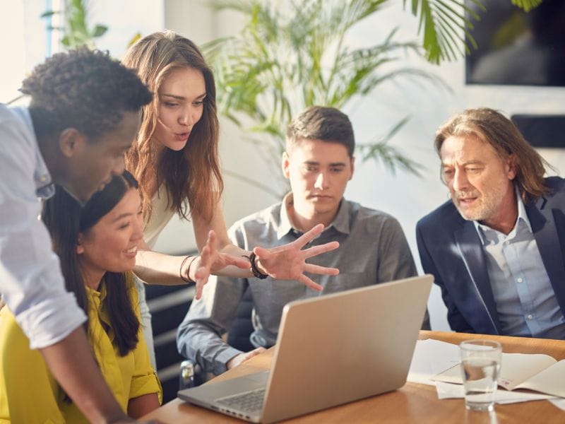 Mastering the Art of Lead Generation: Innovative Solutions for Bad Credit Car Dealerships 1 A group of salesmen in the office brainstorming on how to understand the challenges in lead generation and finding solutions for bad credit car dealerships.