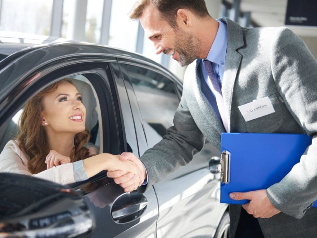 Understanding Auto Lead Generation 5 Challenges & Solutions 1 this sales manager is finishinbg a sale made by an auto lead generation campaign